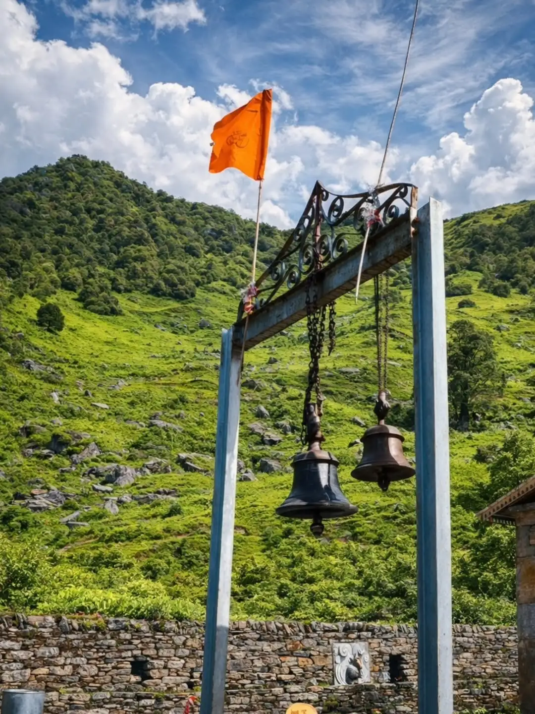 Madmaheshwar Temple in lush green valley with clouds